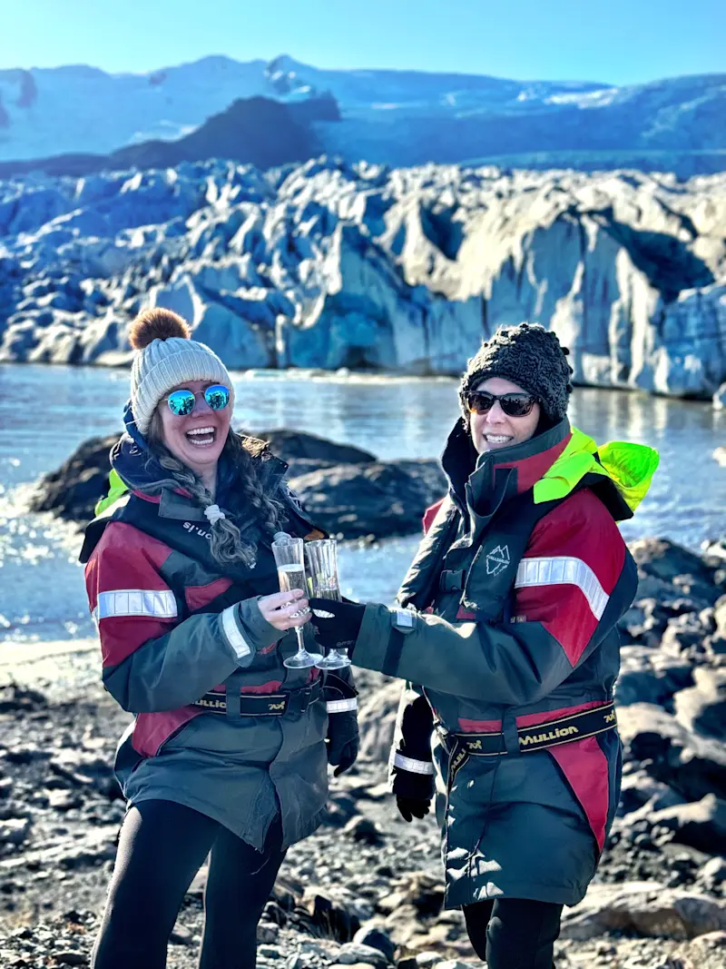 Clinking our champagne glasses at Fjallsárlón Glacier Lagoon in Iceland.