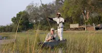 Nat Hab guest on mokoro safari, Okavango Delta, Botswana.