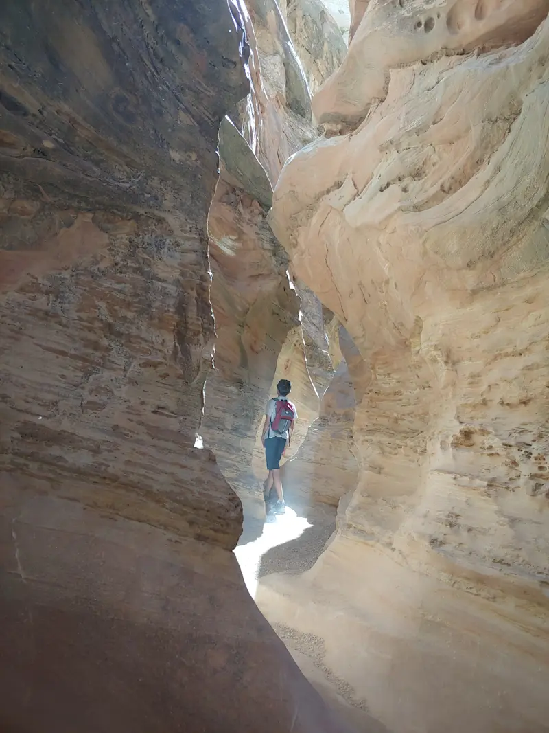 Squeezing through the narrow walls and big textures, Little Horse Slot Canyon, Utah.