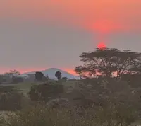 Beautiful sunset at Nat Hab's Mara East Camp in Kenya.