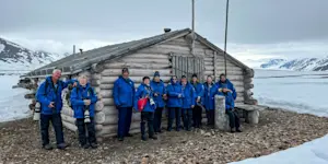 Guests in front of a cabin in Mushamna, Svalbard, Norway.