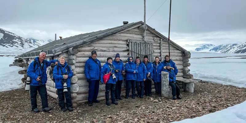 Guests in front of a cabin in Mushamna, Svalbard, Norway.