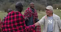 Maasai and guest at Nat Hab’s Mara East Camp, Private Mara Conservancy, Kenya.
