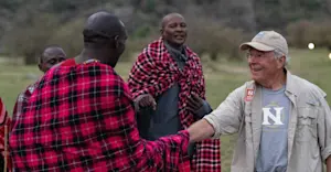 Maasai and guest at Nat Hab’s Mara East Camp, Private Mara Conservancy, Kenya.