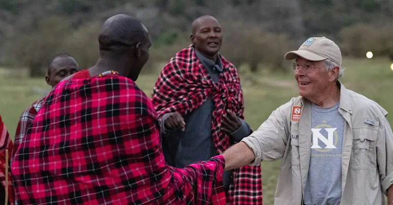 Maasai and guest at Nat Hab’s Mara East Camp, Private Mara Conservancy, Kenya.