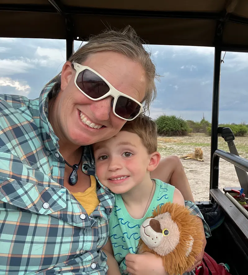 My son and a lion in Chobe in Botswana. 