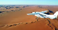 Bush plane flying over the Namib Desert, Namibia.