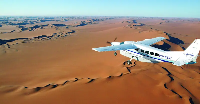 Bush plane flying over the Namib Desert, Namibia.