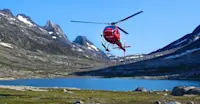 Helicopter landing at Nat Hab's Base Camp Greenland, East Greenland.