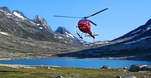 Helicopter landing at Nat Hab's Base Camp Greenland, East Greenland.