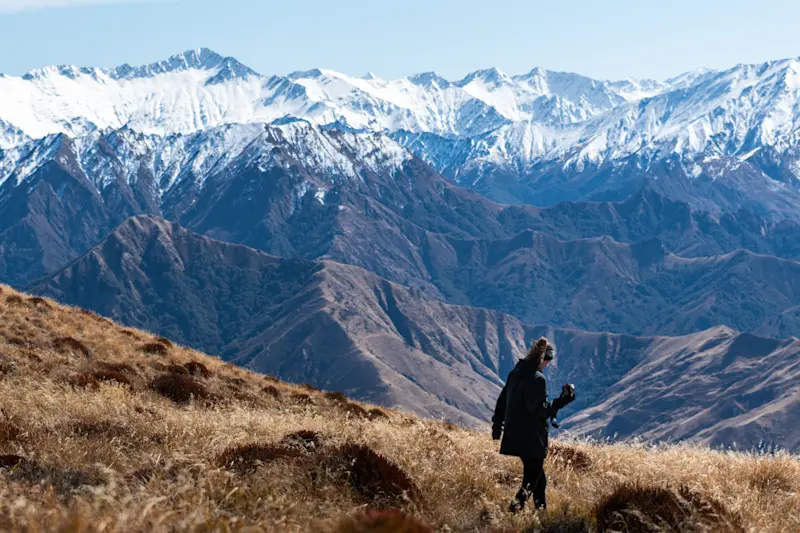 Hiking along the mountain range in Queenstown, New Zealand.