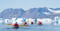 Nat Hab guests kayaking, Sermilik Fjord, Greenland.