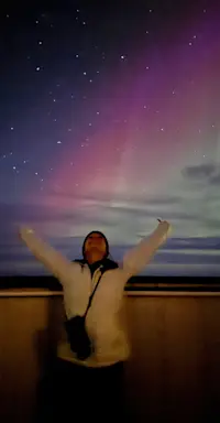 Enjoying the Northern Lights from the Tundra Lodge on Hudson Bay, Churchill, Canada.