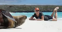 Nat Hab guest with Galapagos sea lion, San Cristobal Island, Galapagos, Ecuador.