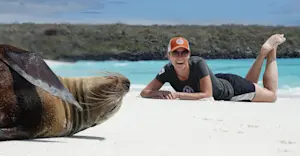 Nat Hab guest with Galapagos sea lion, San Cristobal Island, Galapagos, Ecuador.