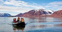Travelers take a Zodiac cruise, Svalbard, Norway.