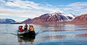 Travelers take a Zodiac cruise, Svalbard, Norway.