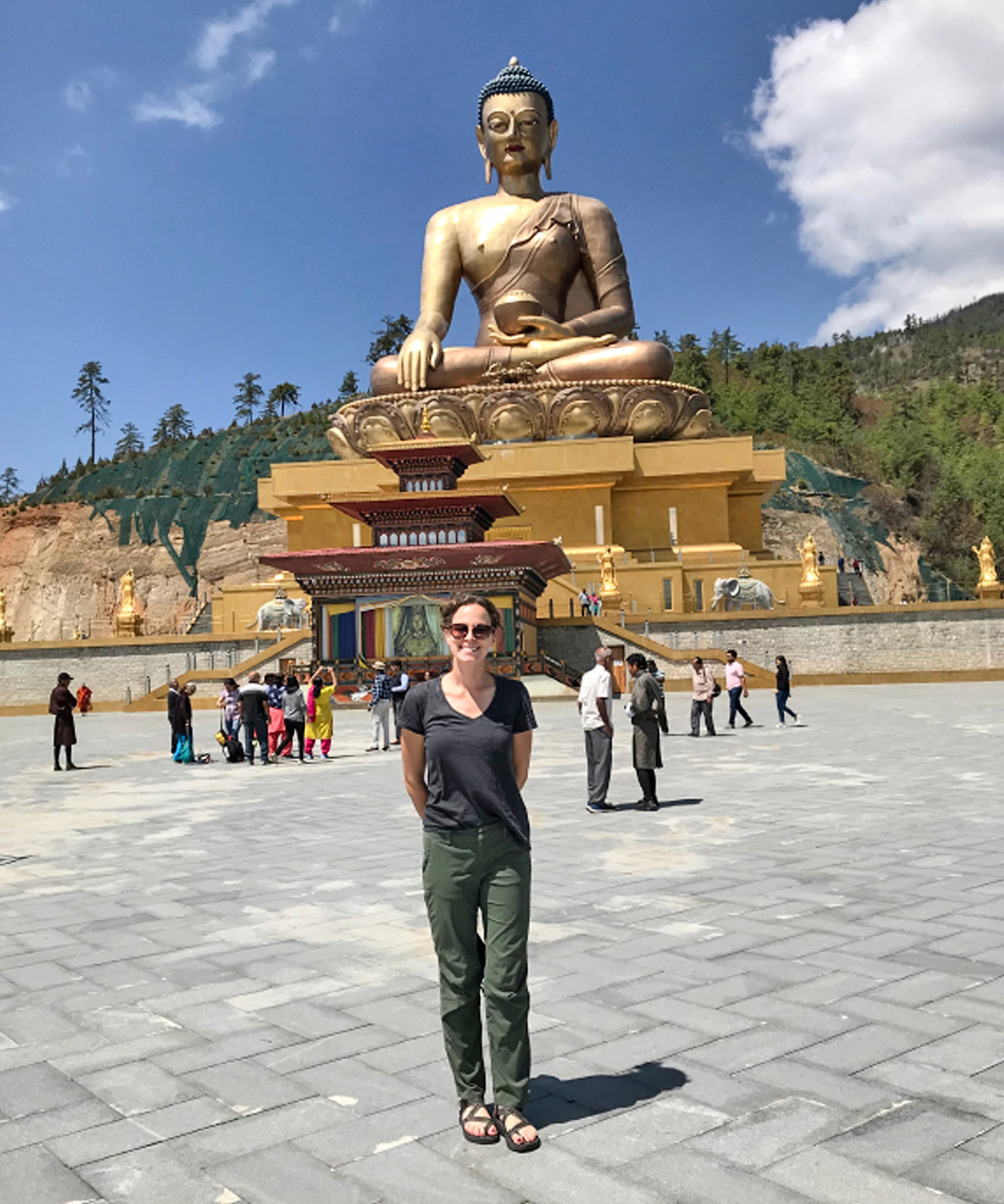 Standing in the glow of a giant golden Buddha in Bhutan.