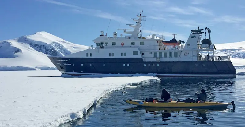 Nat Hab guests kayaking near the Hanse Explorer, Antarctica.