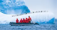 Guests in Zodiac view chinstrap penguins, Antarctica.