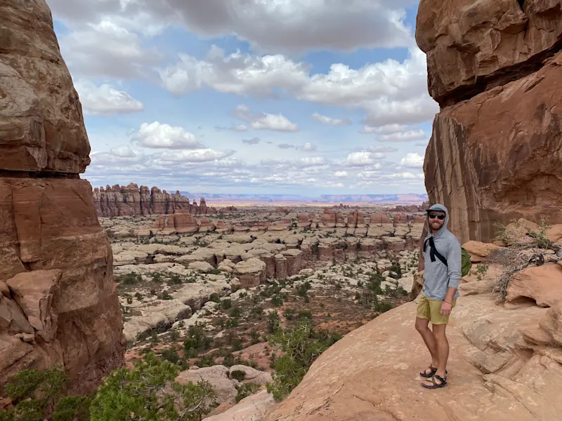 Walking through rock towers and open desert in Needles District, Canyonlands National Park, Utah.