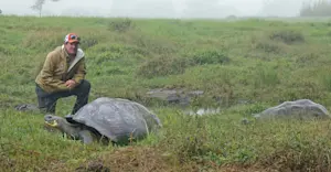 Posing with 2 giant tortoises at Nat Hab's Tortoise Camp. 