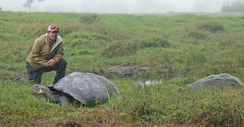 Posing with 2 giant tortoises at Nat Hab's Tortoise Camp. 