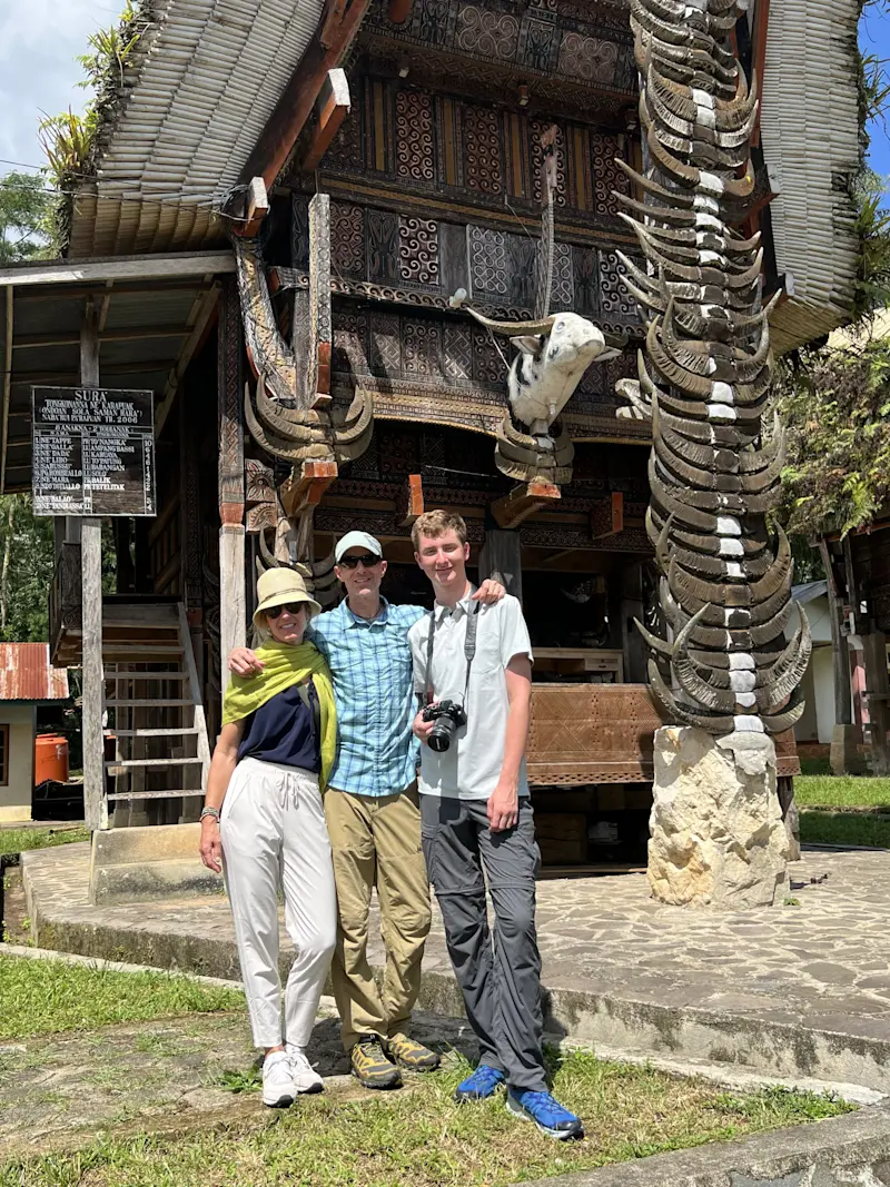 In front of a traditional Torajan house, South Sulawesi, Indonesia.