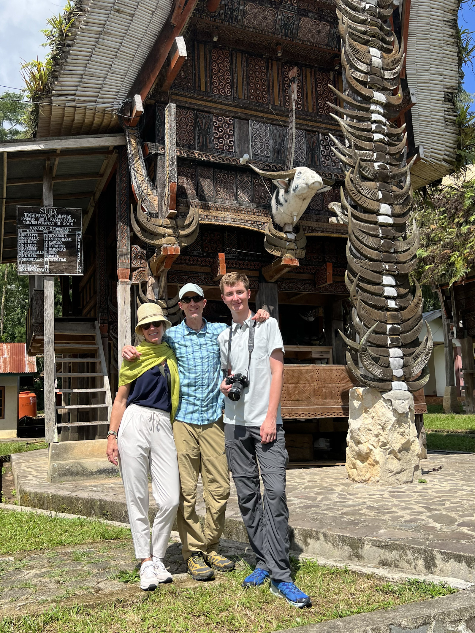 In front of a traditional Torajan house, South Sulawesi, Indonesia.