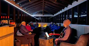 Travelers enjoying the comforts of Nat Hab's Aurora Pod®