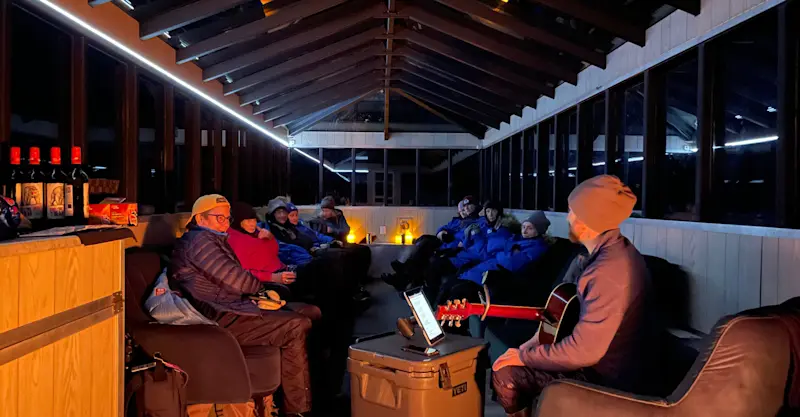 Travelers enjoying the comforts of Nat Hab's Aurora Pod®