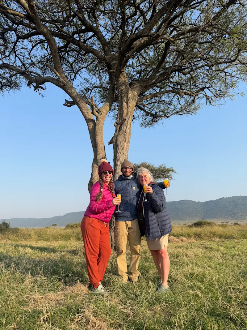 Celebrating an unforgettable morning with a champagne breakfast after a sunrise balloon safari in Tanzania, Africa.