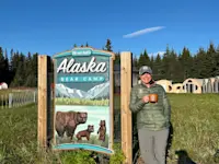 Enjoying a peaceful cup of coffee on the shores of Chinitna Bay, Lake Clark National Park in Alaska.