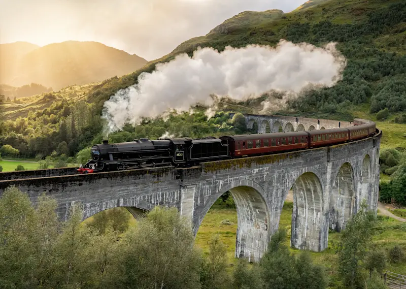 Jacobite Steam Train crossing the Glenfinnan viaduct, Scotland.