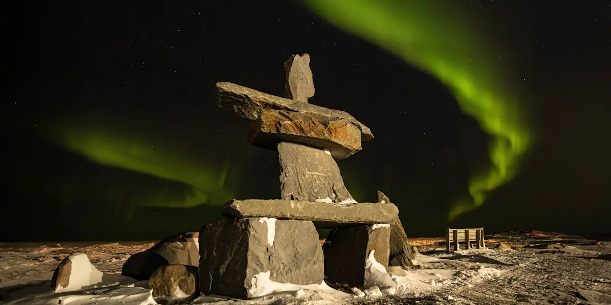 Northern lights above Inukshuk, Churchill, Manitoba.