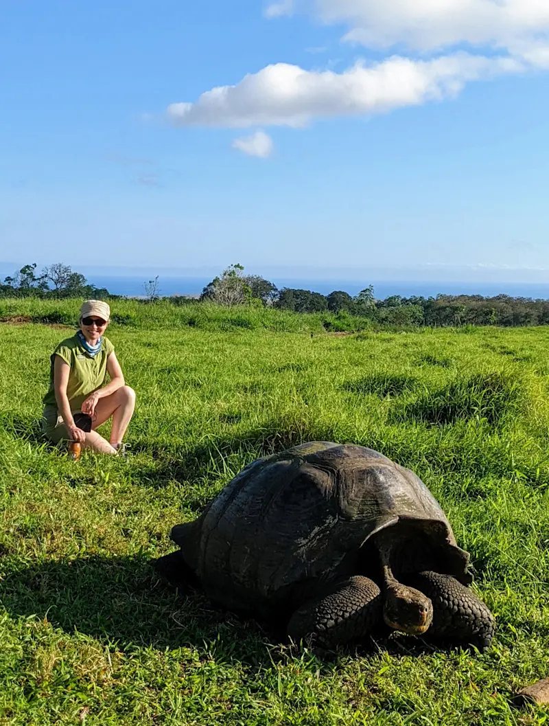 Posing with a giant tortoise on the Galapagos Islands.
