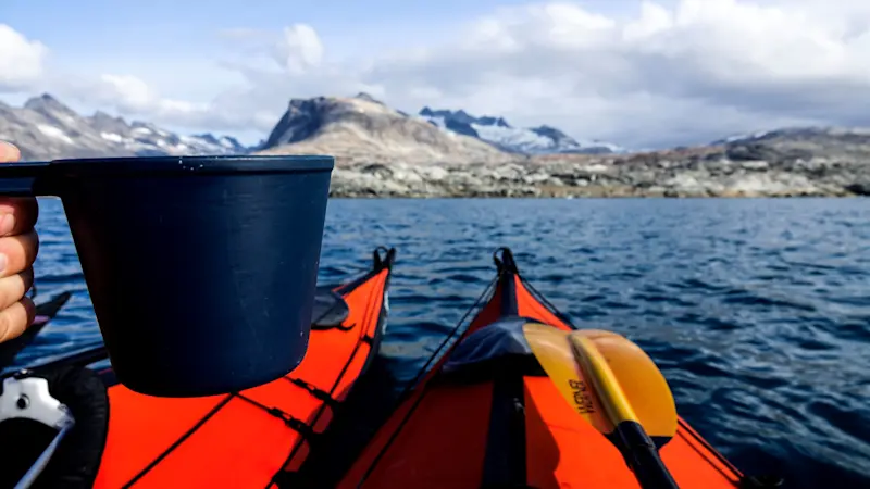 Sipping hot chocolate during a kayaking break in Greenland.