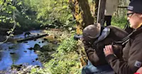 Nat Hab guests and black bear, Great Bear Rainforest, British Columbia.