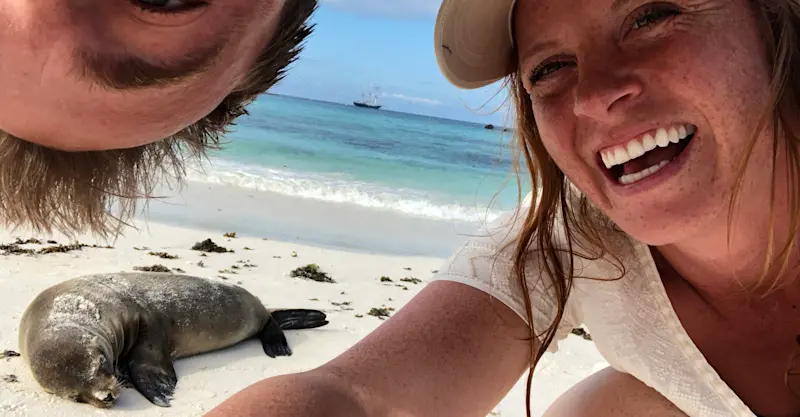 Nat Hab guests and Galapagos sea lion, San Cristobal Island, Galapagos, Ecuador.