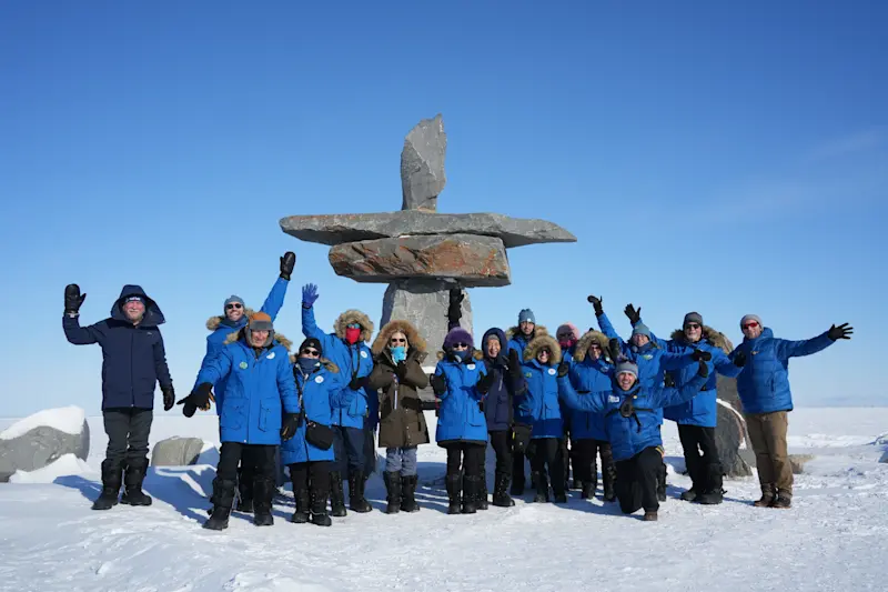 Sharing a memorable group moment at the Inukshuk in Churchill, Manitoba.