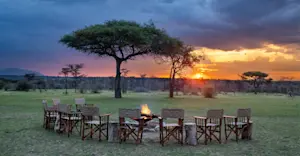 Sunset and campfire at Nat Hab's Mara East Camp, Private Mara Conservancy, Kenya.