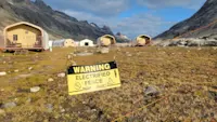 Heeding caution near an electric fence at Base Camp Greenland.