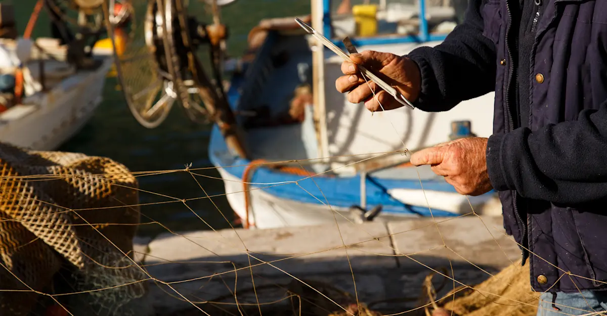 Sciacca fisherman mends net, Sicily, Italy.