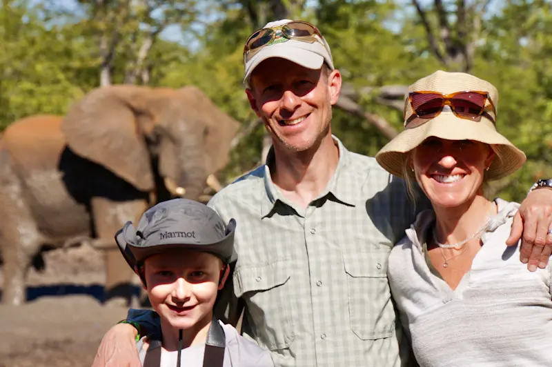 Family of Courters, in front of family of elephants at the Malilangwe Wildlife Reserve in Zimbabwe.