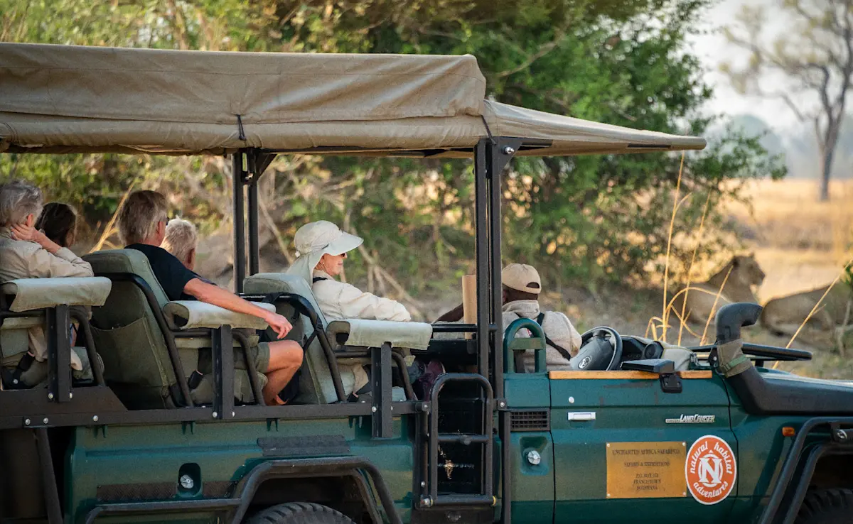 Guests viewing lions, Okavango North, Botswana.