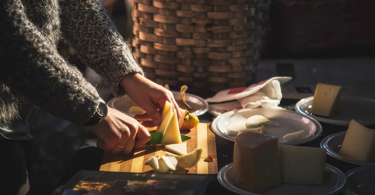 Local host preparing an artisanal cheese board, Basque, Spain.