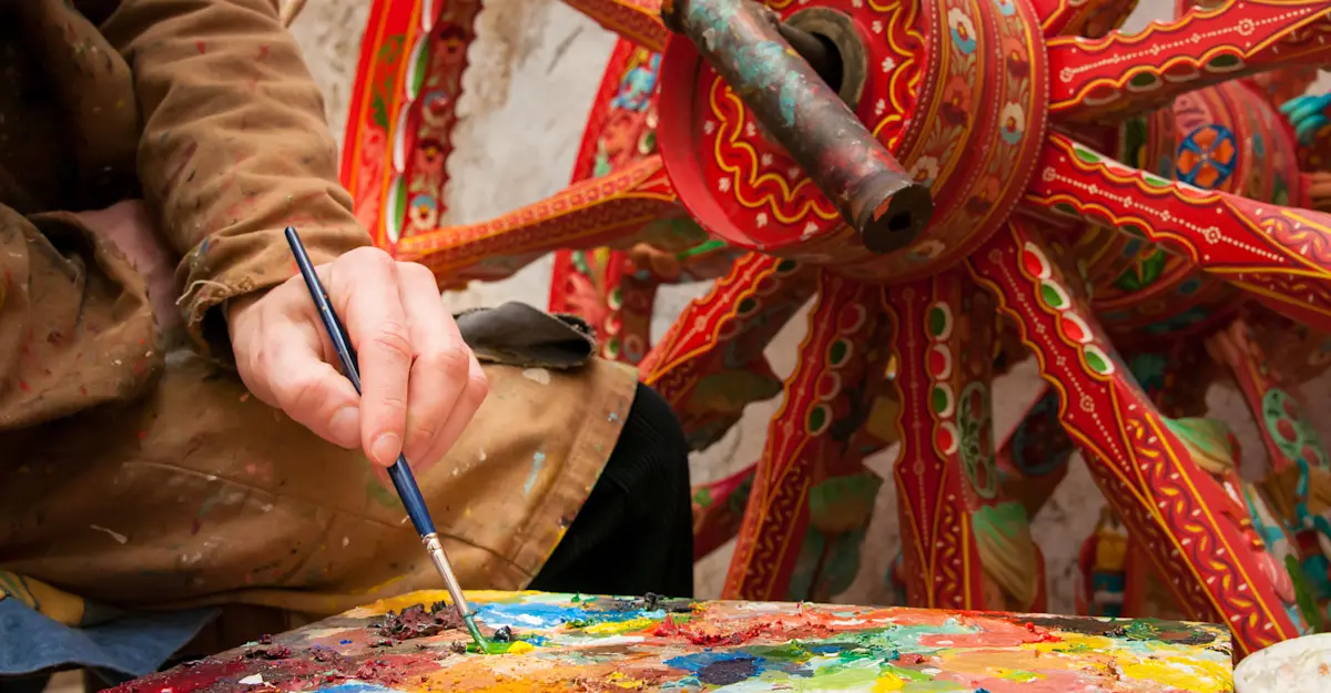 Folk artist paints traditional cart, Sicily, Italy. 