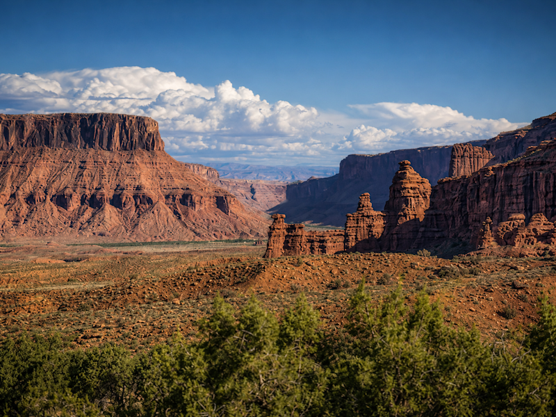 Red rock formations rise above the desert landscape near Moab, Utah.