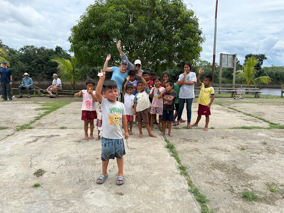  Isla and Tania with the local kiddos in Peru.
