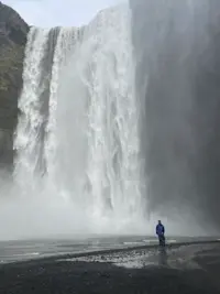 Standing in the mist of mighty falls in Iceland.